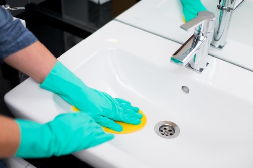 Local cleaner working in a kitchen with practical access challenges in N1